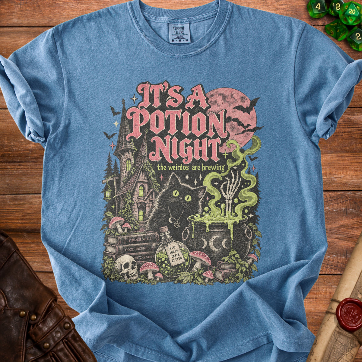 Blue t-shirt with "It's a Potion Night" text and spooky Halloween scene.