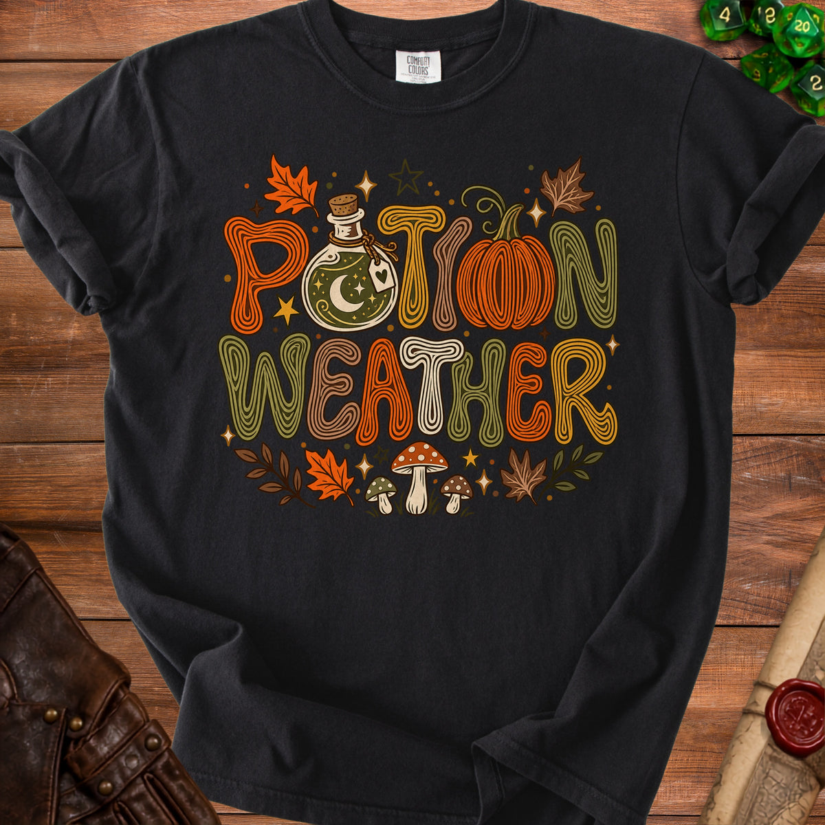 Black t-shirt with "Potion Weather" text, potion bottle, pumpkin, and mushrooms.
