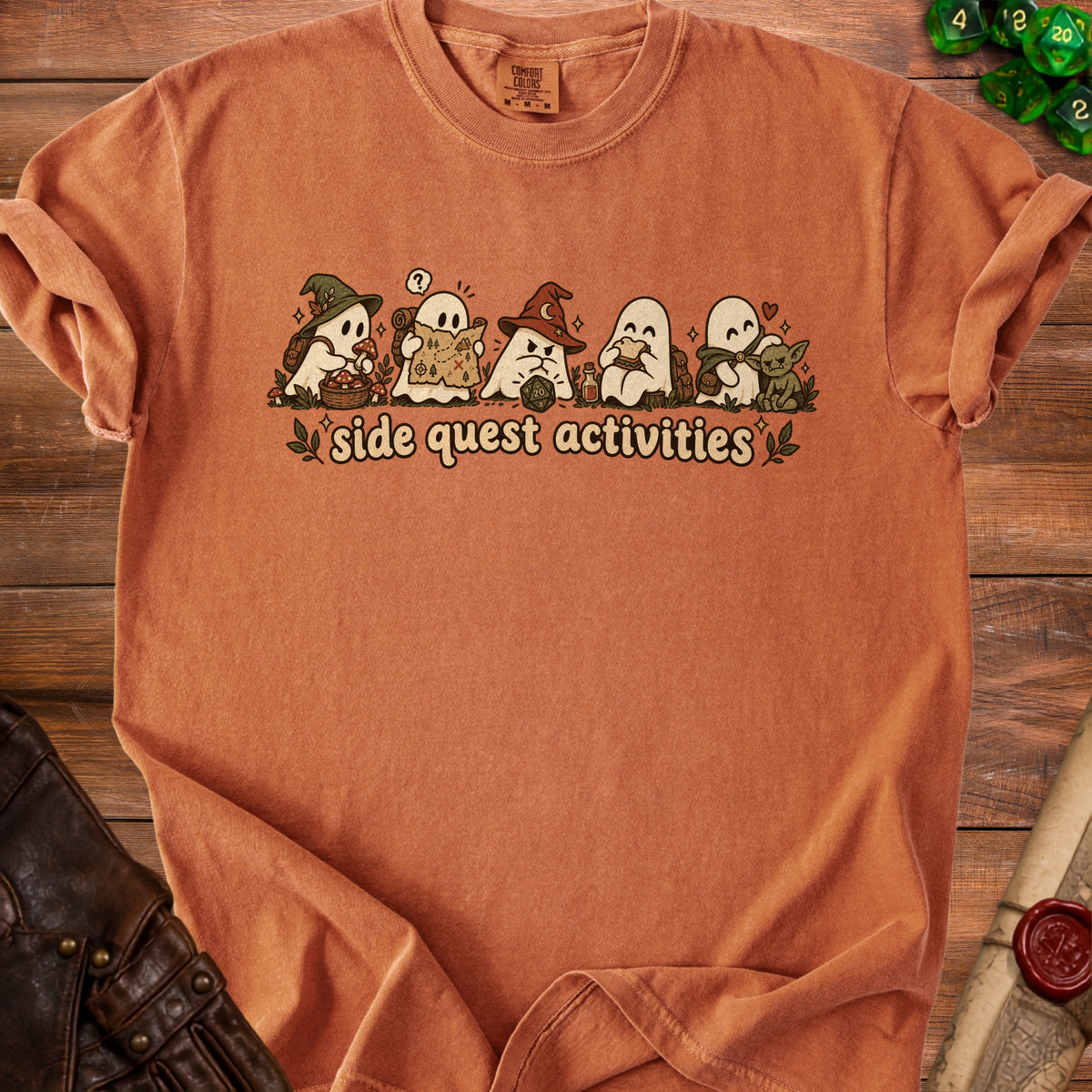 Orange t-shirt with ghosts reading maps, eating sandwiches, and playing games.
