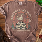 Brown t-shirt with a graphic of a goose on skulls under an archway with text.