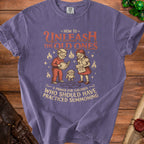 Purple shirt featuring children, a creature, and text about summoning old ones.