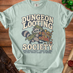 Light blue t-shirt with raccoon character holding treasure chest and text "Dungeon Looting Society".