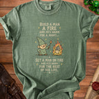 Green t-shirt with gnome holding a torch near a fire and text about warmth.
