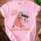 Pink t-shirt with illustration of witch and text "LOW MANA HIGH DRAMA".