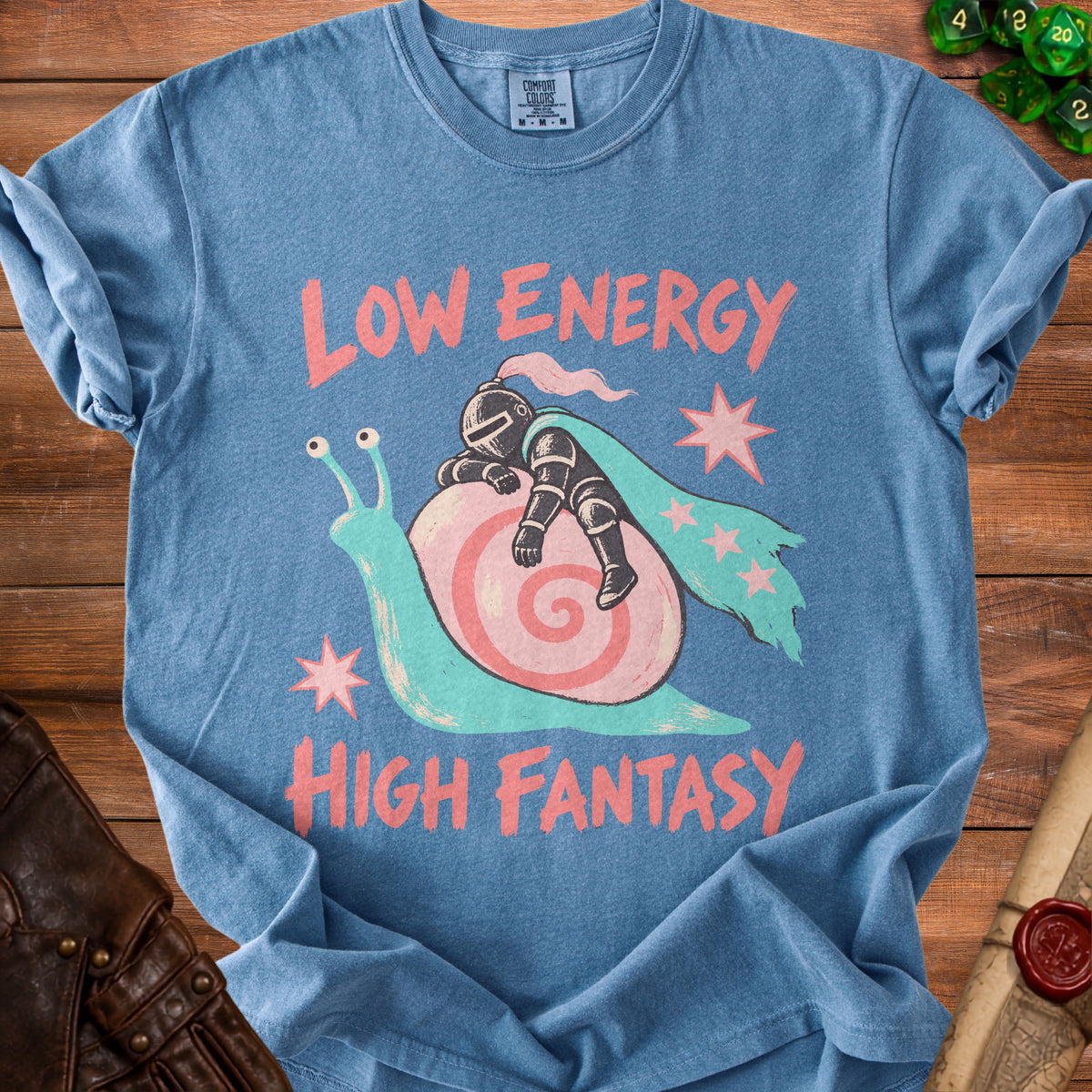 Blue t-shirt featuring a knight sleeping on a snail, surrounded by the text Low Energy High Fantasy.