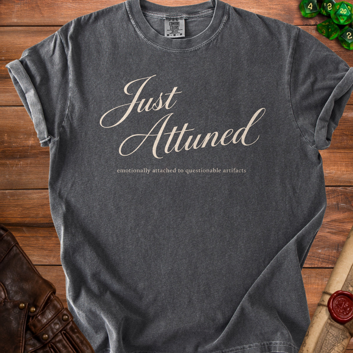 Dark grey t-shirt with "Just Attuned emotionally attached to questionable artifacts" text.