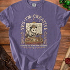 Purple t-shirt with opossum wearing Viking helmet, drawing a map. Text says "Yes, I'm Creative" and "I Create All of My Own Problems."