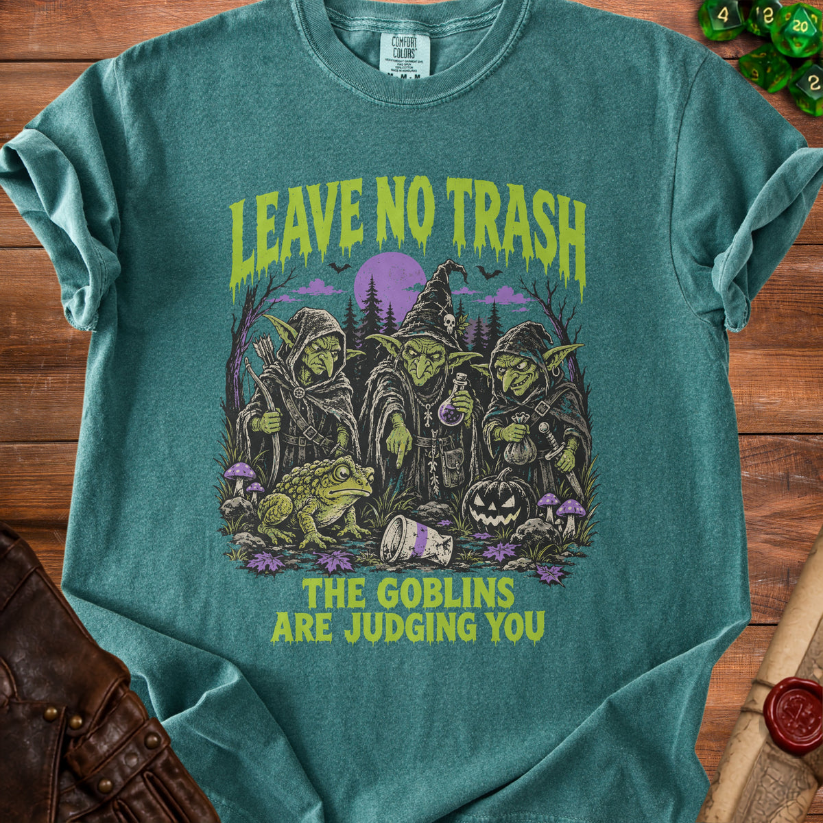 T-shirt with goblins, frog, pumpkin, and text "LEAVE NO TRASH, THE GOBLINS ARE JUDGING YOU".