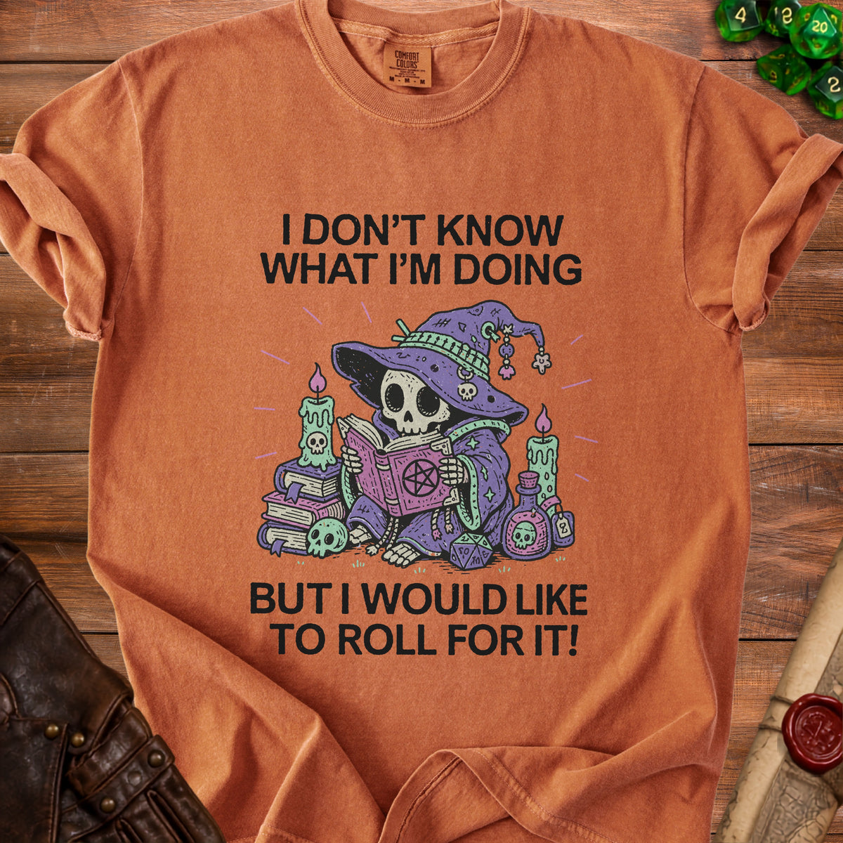 Orange t-shirt with skeleton wizard graphic and text "I DON'T KNOW WHAT I'M DOING BUT I WOULD LIKE TO ROLL FOR IT!"