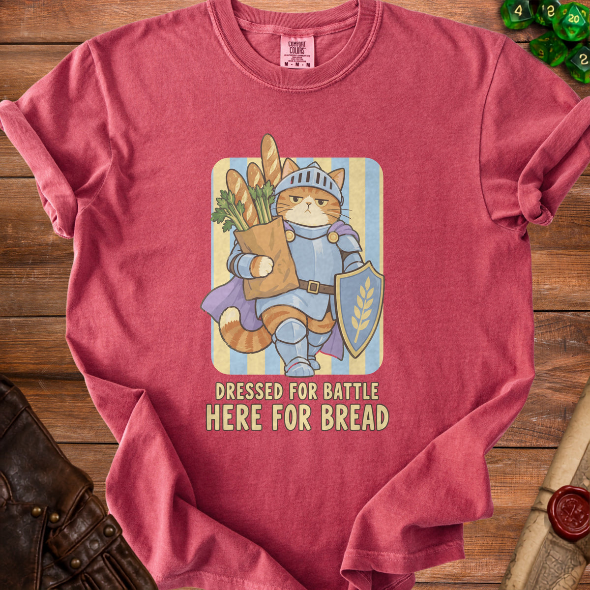 Cat in knight armor carrying groceries, text "Dressed for Battle Here for Bread".