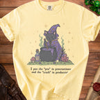 Yellow t-shirt with a graphic of a cat witch and text about procrastination and productivity.