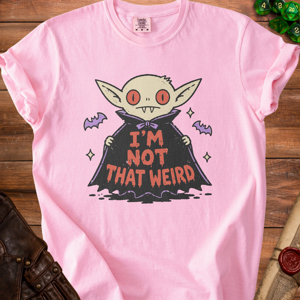 Pink t-shirt with a cartoon vampire graphic that says "I'M NOT THAT WEIRD".