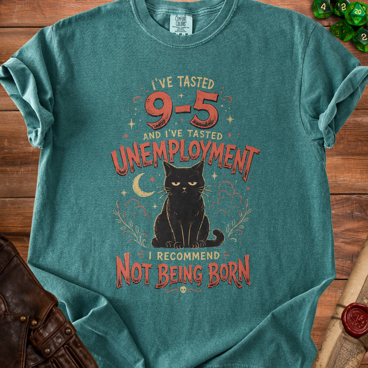T-shirt with black cat graphic and text "I've tasted 9-5 and I've tasted unemployment. I recommend not being born."
