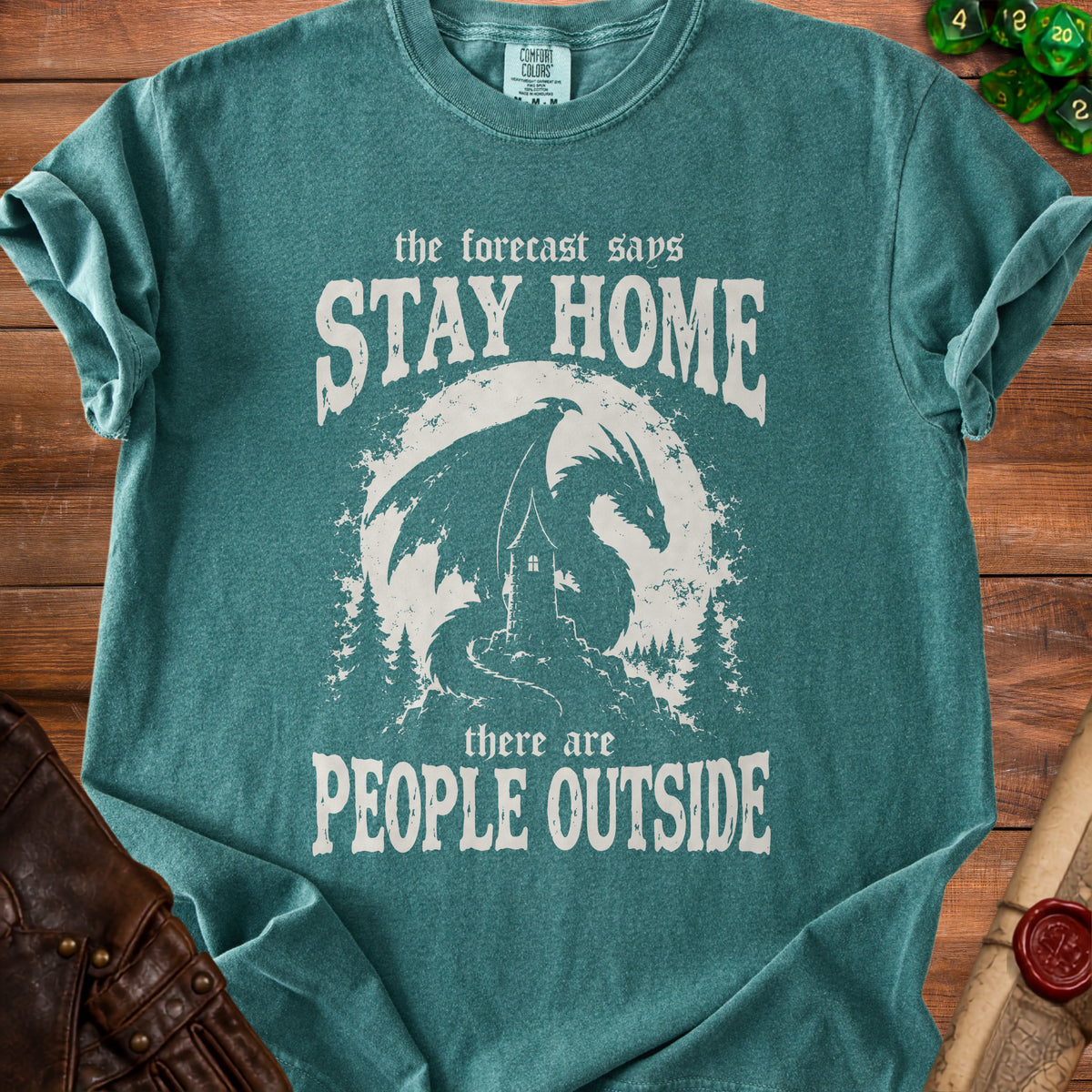 Green t-shirt with dragon, lighthouse, and text "The forecast says Stay Home, there are People Outside."