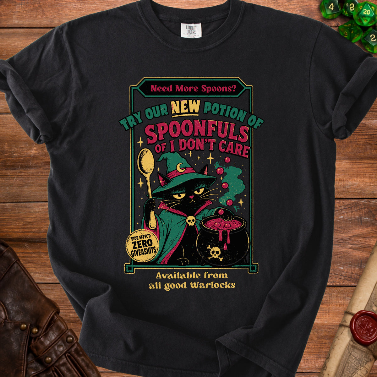 Black t-shirt with witch cat illustration and text "SPOONFULS OF I DON'T CARE".