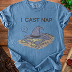 Blue t-shirt with text "I CAST NAP" and sleeping wizard graphic.