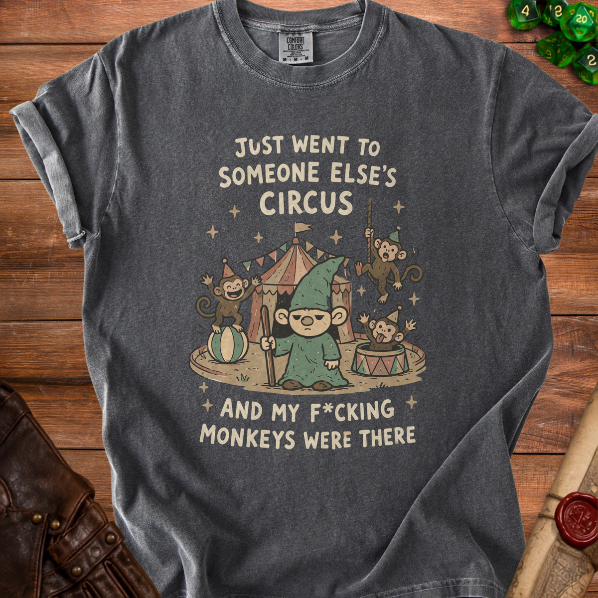 Dark grey t-shirt graphic: gnome and monkeys at a circus with text.