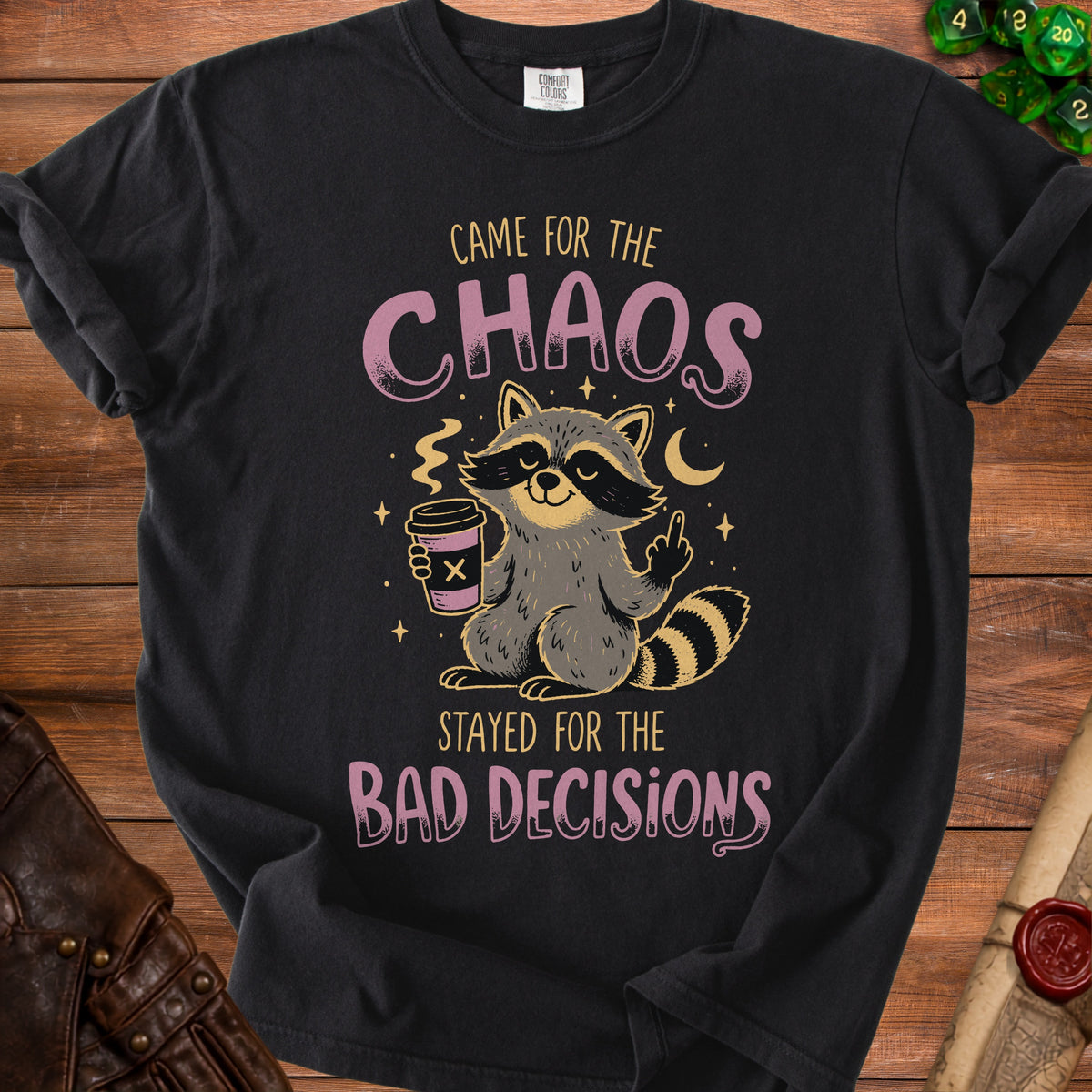 T-shirt with a raccoon holding coffee and text "CAME FOR THE CHAOS STAYED FOR THE BAD DECISIONS".