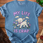 Blue t-shirt with graphic of lamb saying "MY LIFE IS CRAP" and flowers.