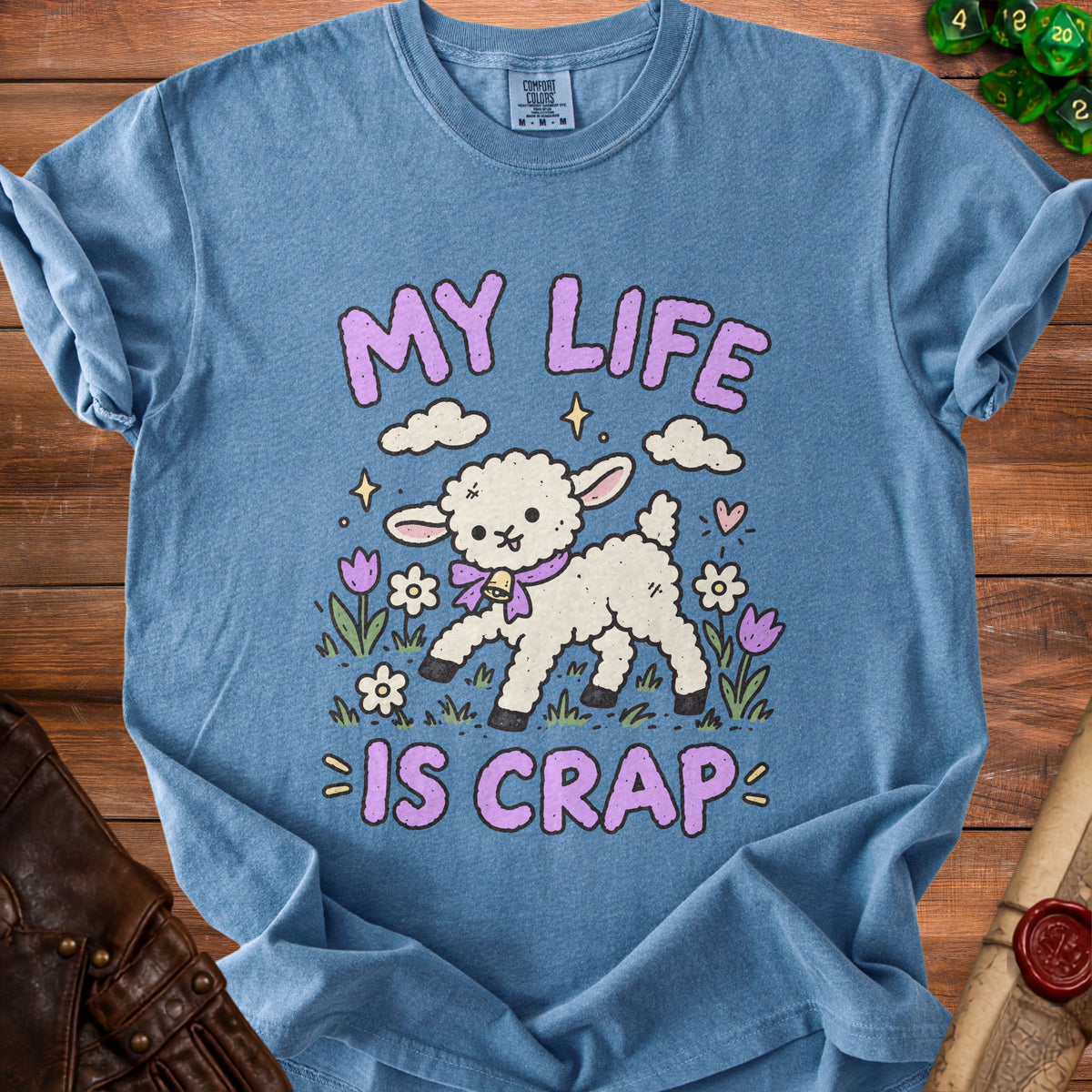 Blue t-shirt with graphic of lamb saying "MY LIFE IS CRAP" and flowers.