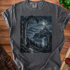 Dark t-shirt with a gothic castle, mountains, and cloaked figure under a full moon.