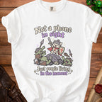 White t-shirt with a cat knight fighting goblins, text "Not a phone in sight".