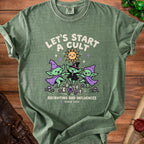 Green t-shirt with cartoon witches, sun, and text "Let's Start A Cult Recruiting Bad Influences".