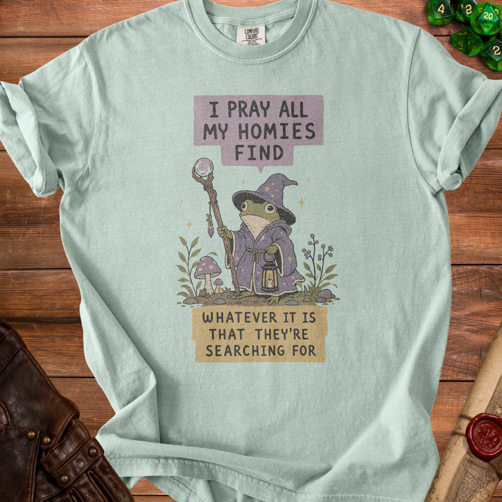 Light blue t-shirt with wizard frog graphic reading "I pray all my homies find whatever it is that they're searching for."