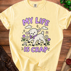 Yellow t-shirt with a cartoon lamb and the text "MY LIFE IS CRAP".
