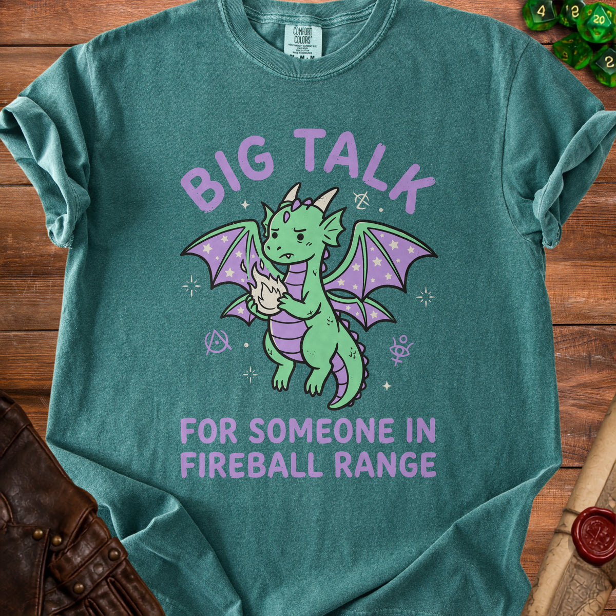 Green t-shirt with purple text and a cartoon dragon holding fire.