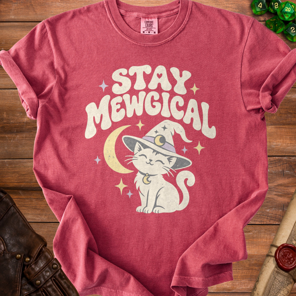 Red t-shirt with white text "STAY MEWGICAL" and a cartoon cat in a witch hat.