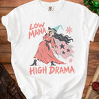 White t-shirt with "Low Mana High Drama" text and a distressed witch graphic.