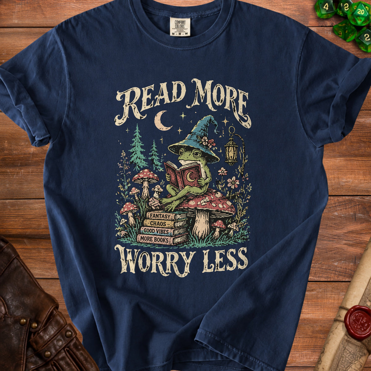 Frog in witch hat reading book with text "Read More Worry Less" and stacked books.