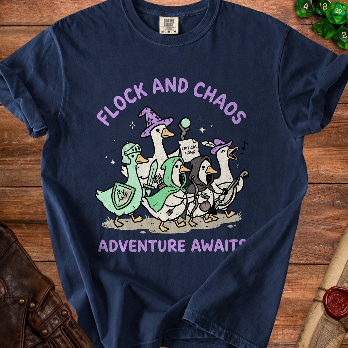 T-shirt with cartoon geese in adventurer outfits and text "FLOCK AND CHAOS ADVENTURE AWAITS".