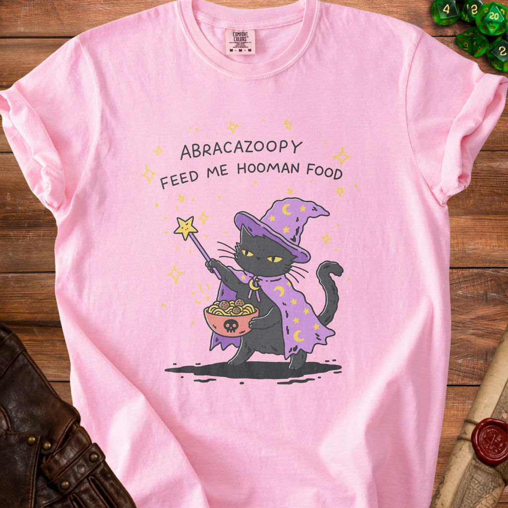 Pink t-shirt with a black cat wizard holding spaghetti and meatballs.