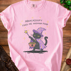 Pink t-shirt with a black cat wizard holding spaghetti and meatballs.