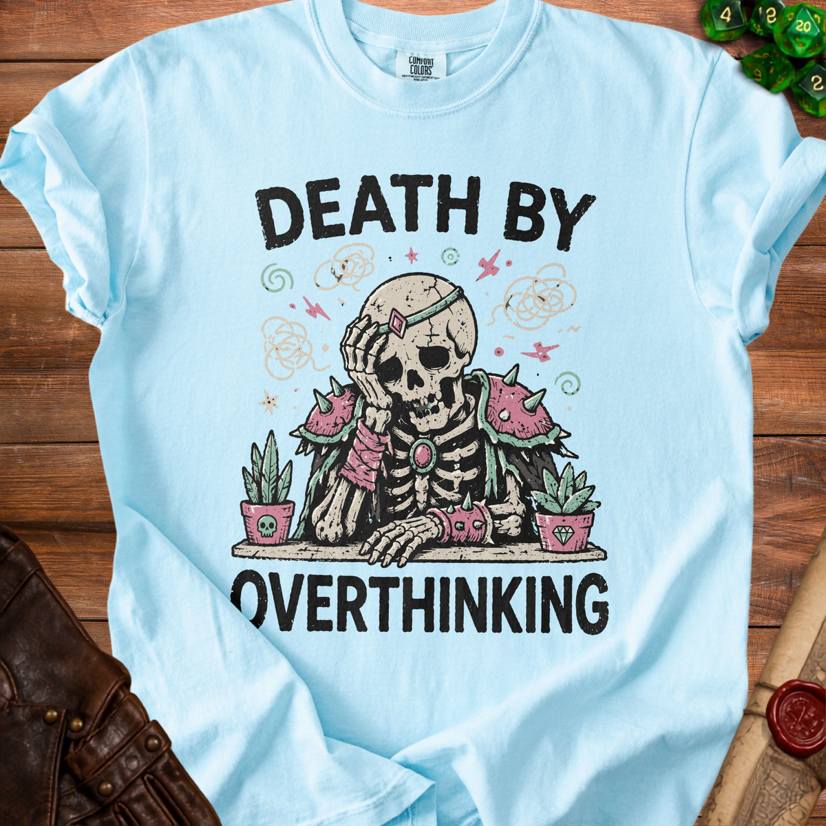 Light blue t-shirt with skeleton graphic and text "DEATH BY OVERTHINKING".