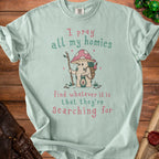 Light teal t-shirt with a cartoon mushroom character and text about searching.