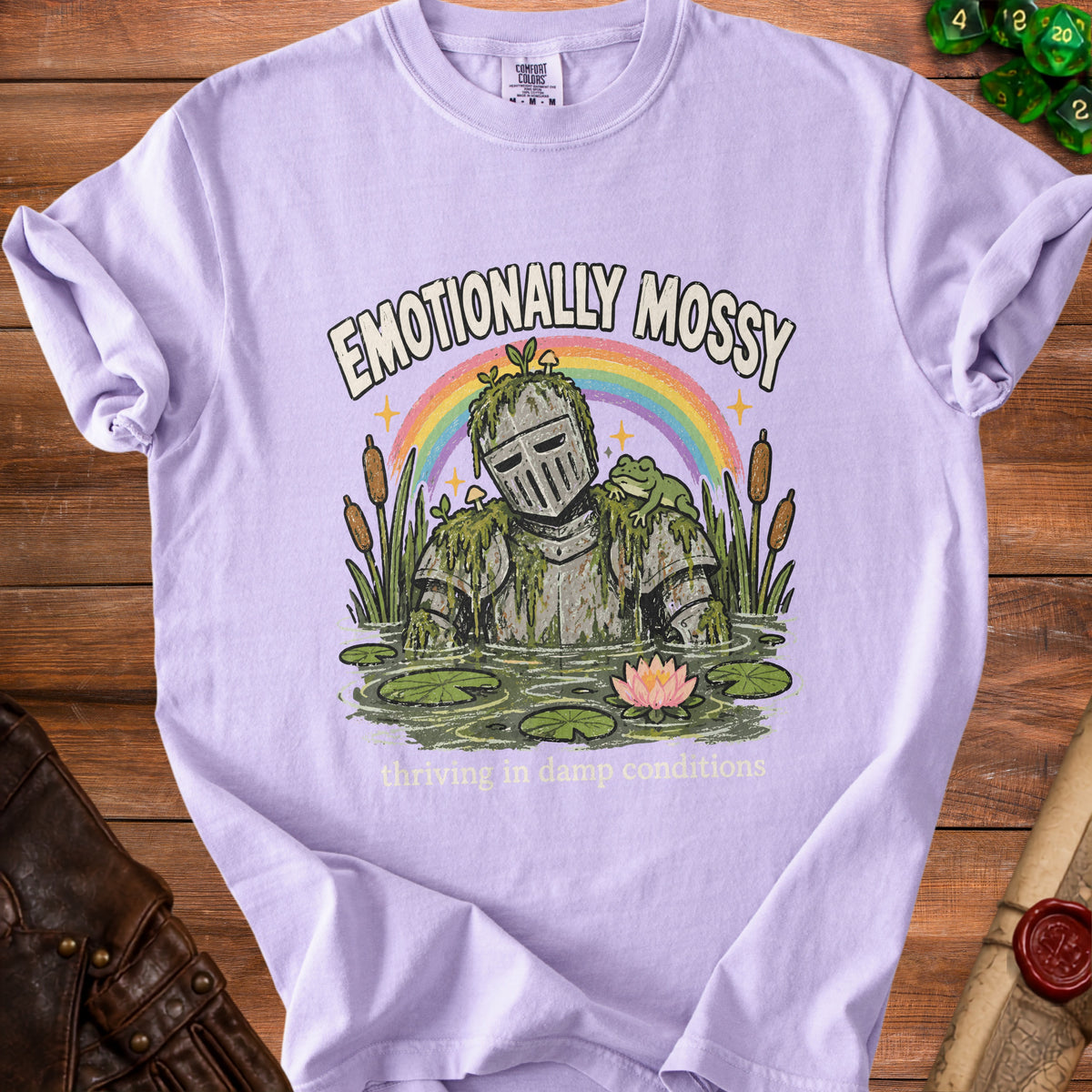 Purple t-shirt with knight in swamp and text "Emotionally Mossy"