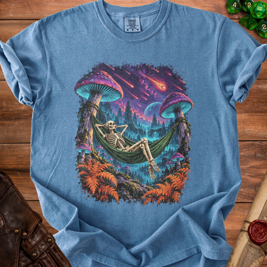 Blue t-shirt with a skeleton relaxing in a hammock with a psychedelic mushroom forest background.