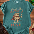 T-shirt with a cartoon frog wearing a cape, holding coffee, and text "Victory at Last" and "A grand, Huzzah."