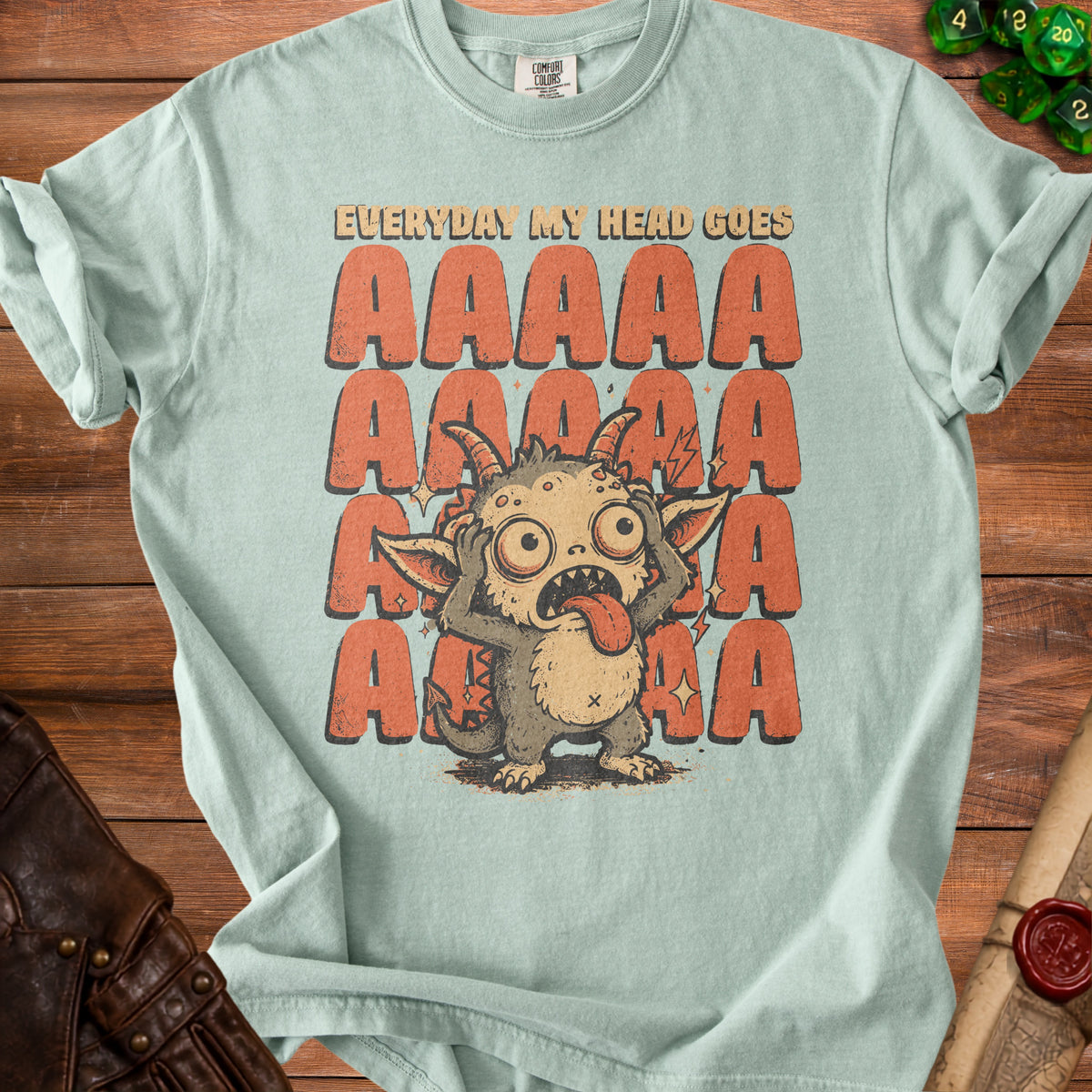 Pale green t-shirt with a distressed monster and "EVERYDAY MY HEAD GOES AAAAA" graphic.