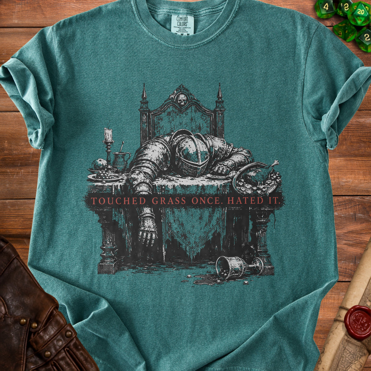 Teal t-shirt with knight's armor asleep at a table, "TOUCHED GRASS ONCE. HATED IT."