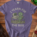 Purple t-shirt with a green goblin at a computer, text reads "I YEARN FOR THE BOG".