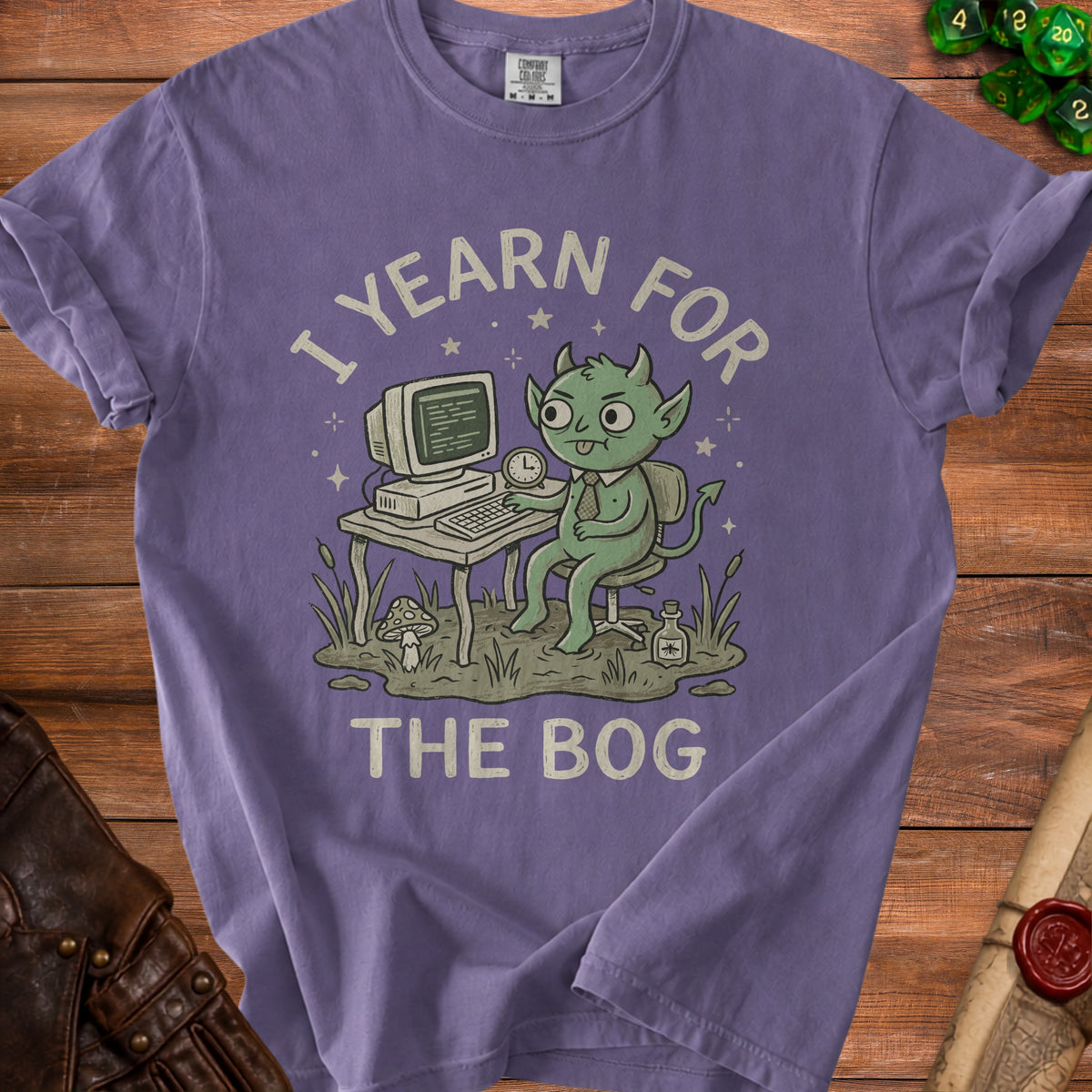 Purple t-shirt with a green goblin at a computer, text reads "I YEARN FOR THE BOG".