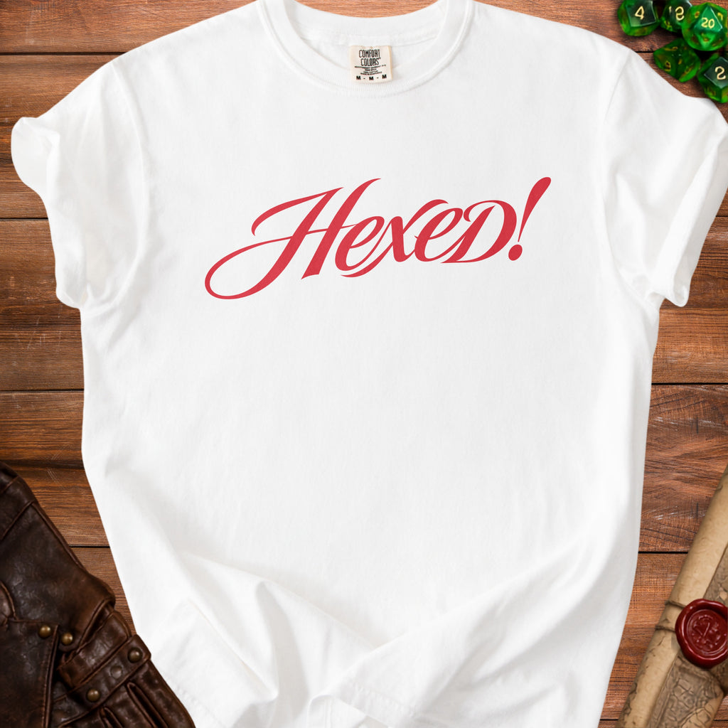 White t-shirt with red script text "Hexed!" on the front.
