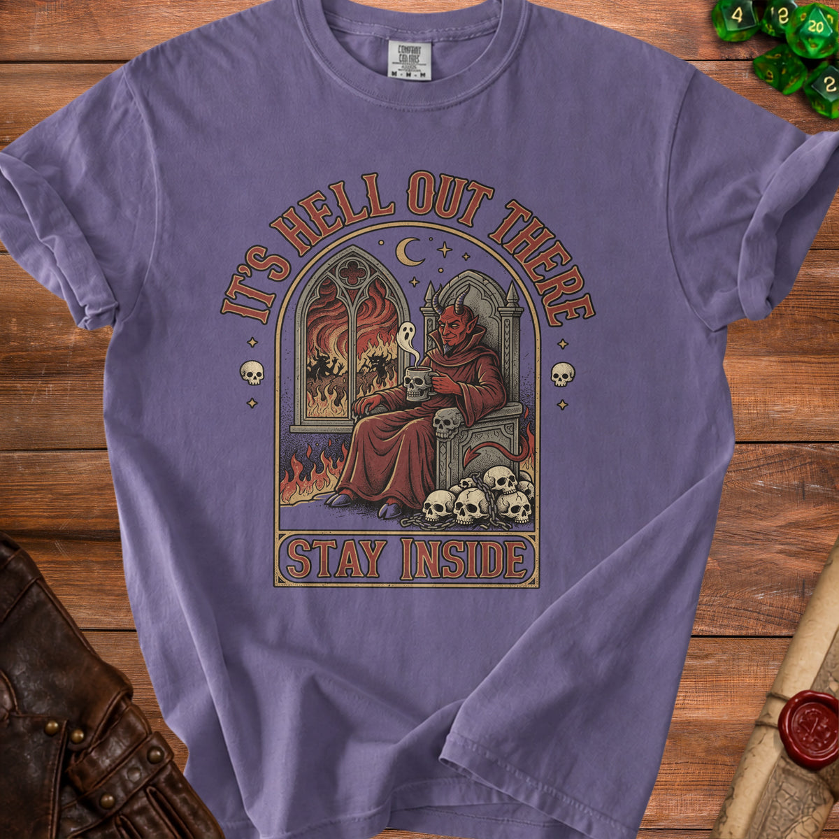 T-shirt with illustration of devil on throne and text "IT'S HELL OUT THERE STAY INSIDE".