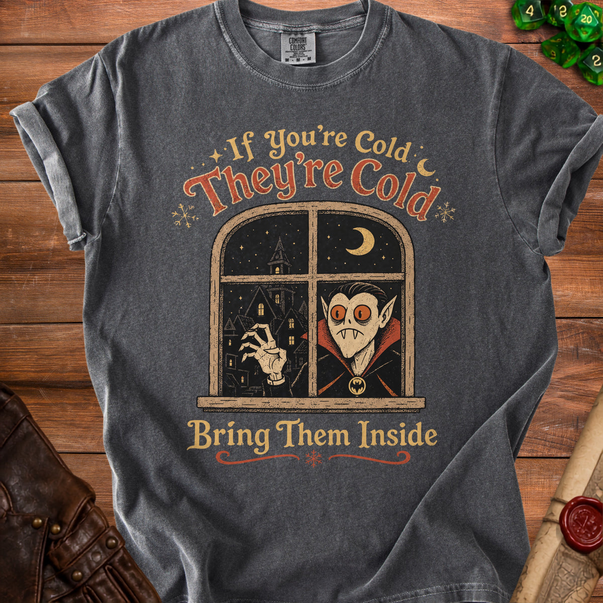 Dark t-shirt with vampire at window graphic: "If You're Cold They're Cold Bring Them Inside".