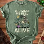 Skeleton watering plants with text "You make me feel alive."