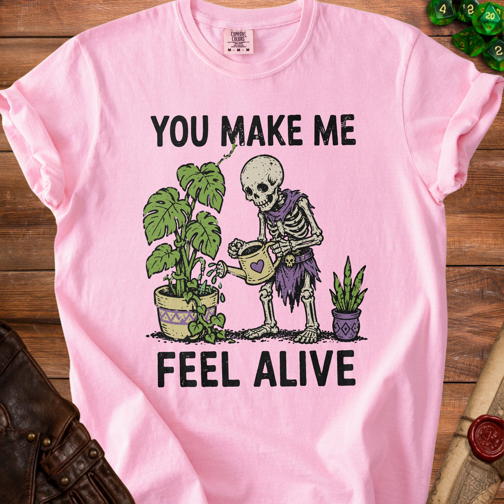 Skeleton watering plants with text "You Make Me Feel Alive"